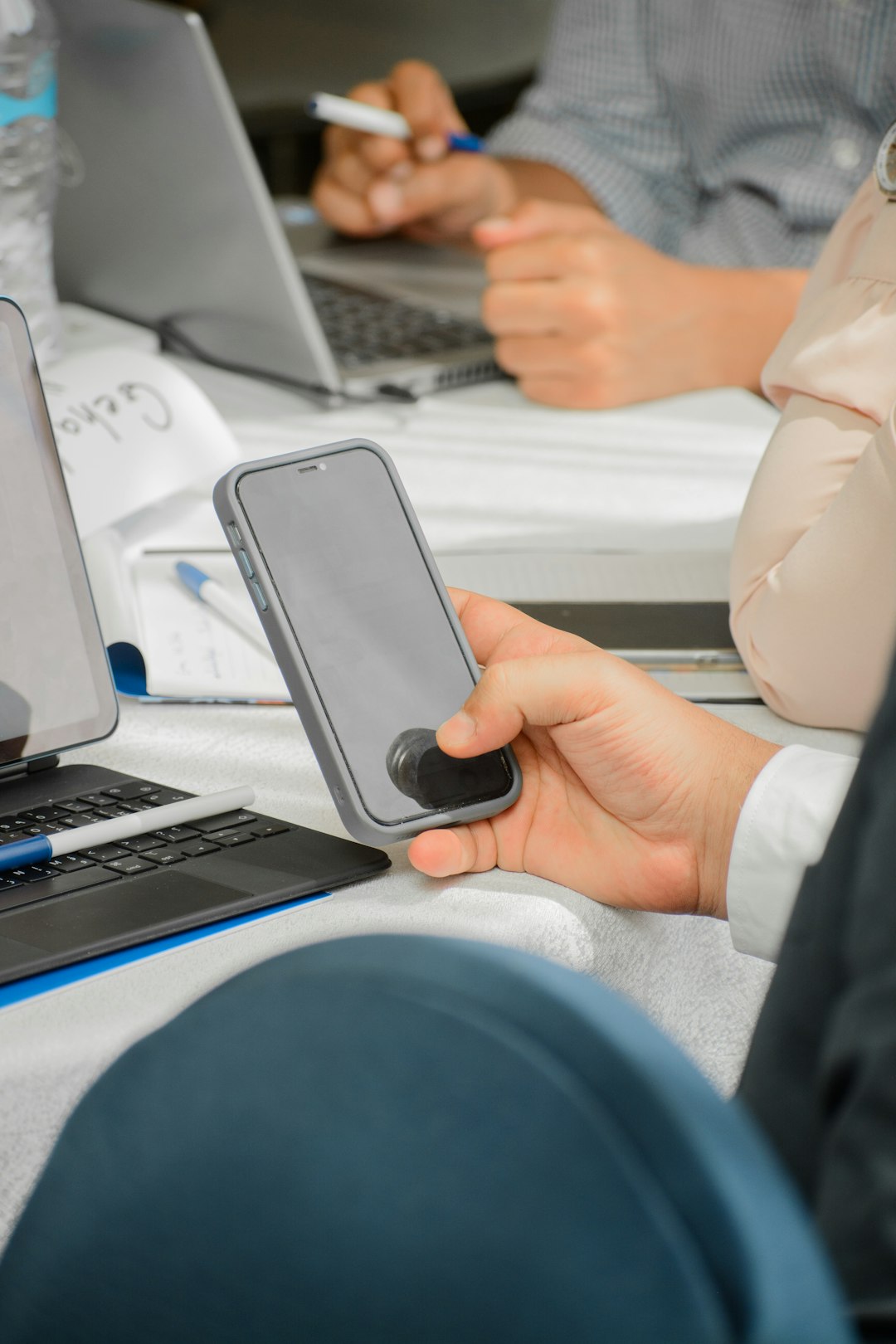 a-person-holding-a-cell-phone-in-front-of-a-laptop-8aru45ogkdm